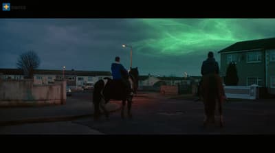 a couple of people riding on the backs of horses
