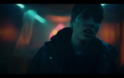 a man in a dark room with his mouth open