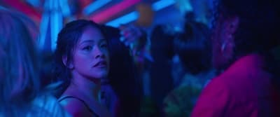 a woman standing in front of a group of people