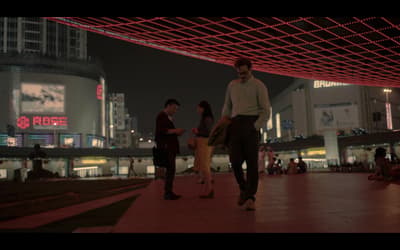 a group of people standing on top of a sidewalk