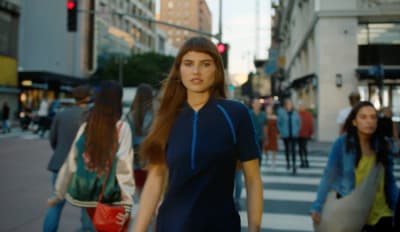 a group of people walking across a street