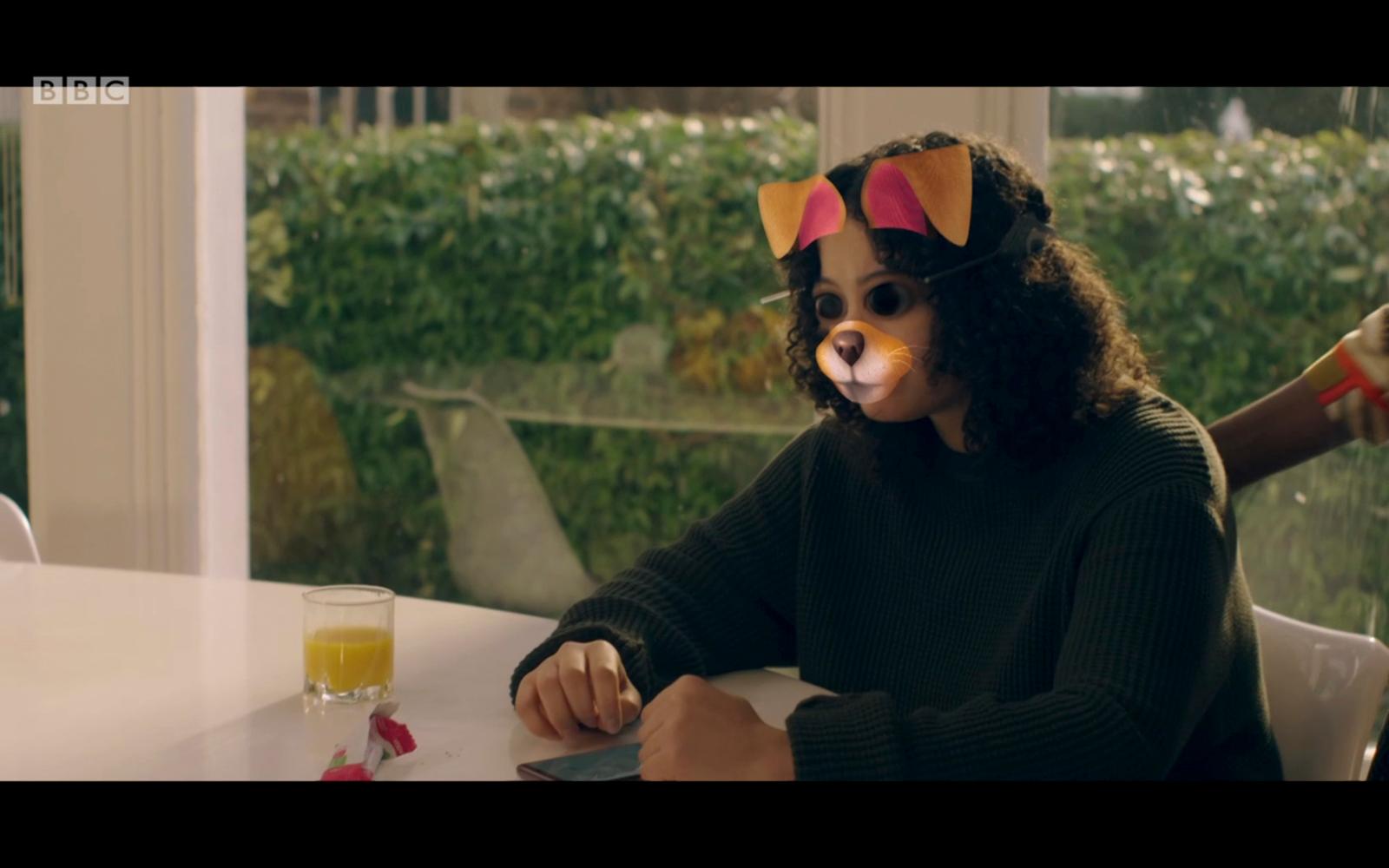 a child wearing a cat costume sitting at a table