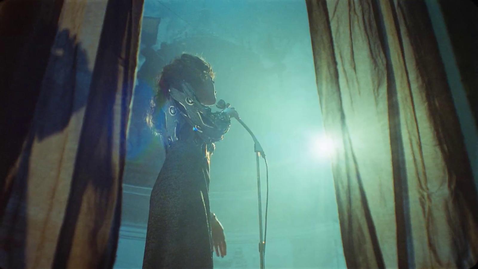 a woman standing in front of a microphone