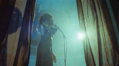 a woman standing in front of a microphone