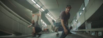 a group of men riding skateboards down a hallway