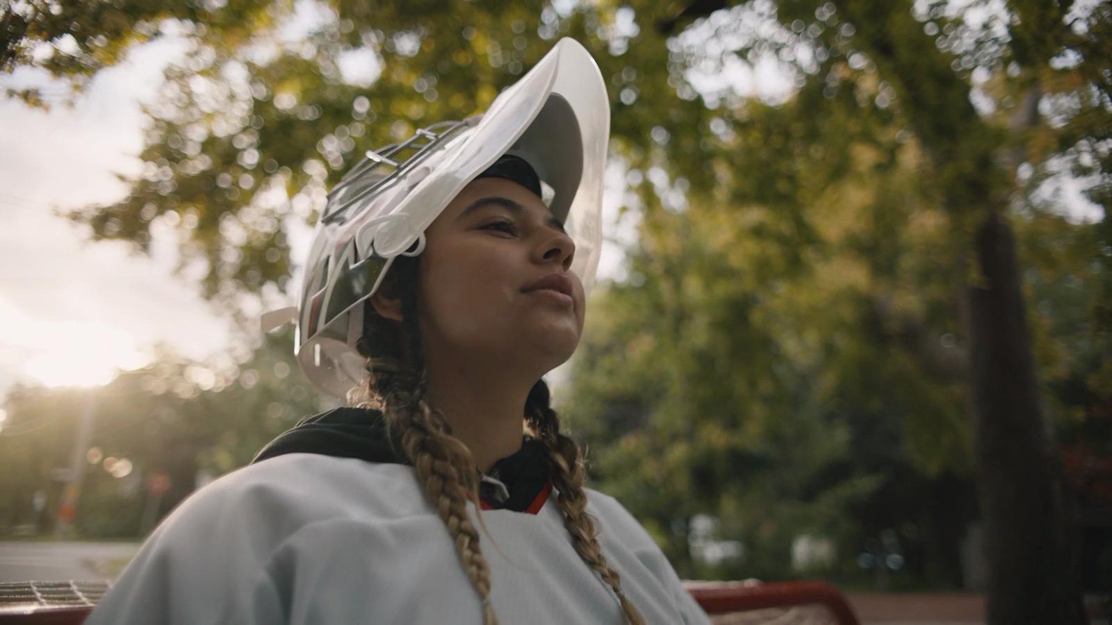 a woman wearing a white hat with a long braid