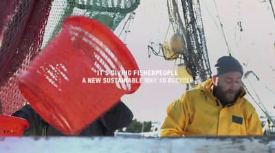 a man in a yellow jacket and a red frisbee