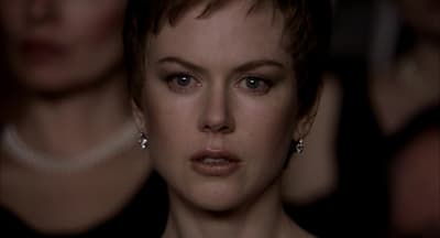 a close up of a person wearing earrings