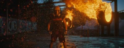 a woman standing in front of a fire