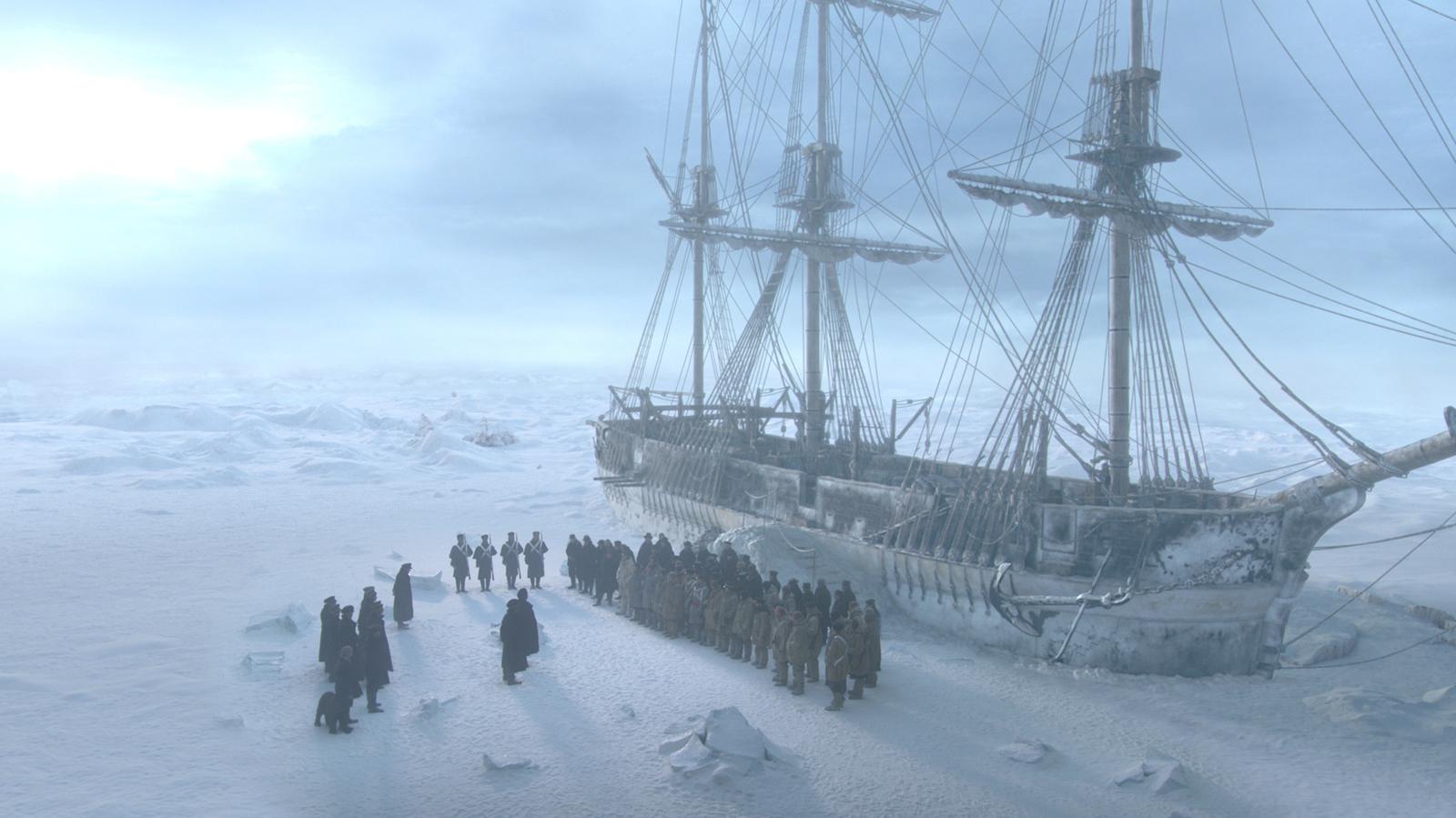 a group of people standing in front of a ship