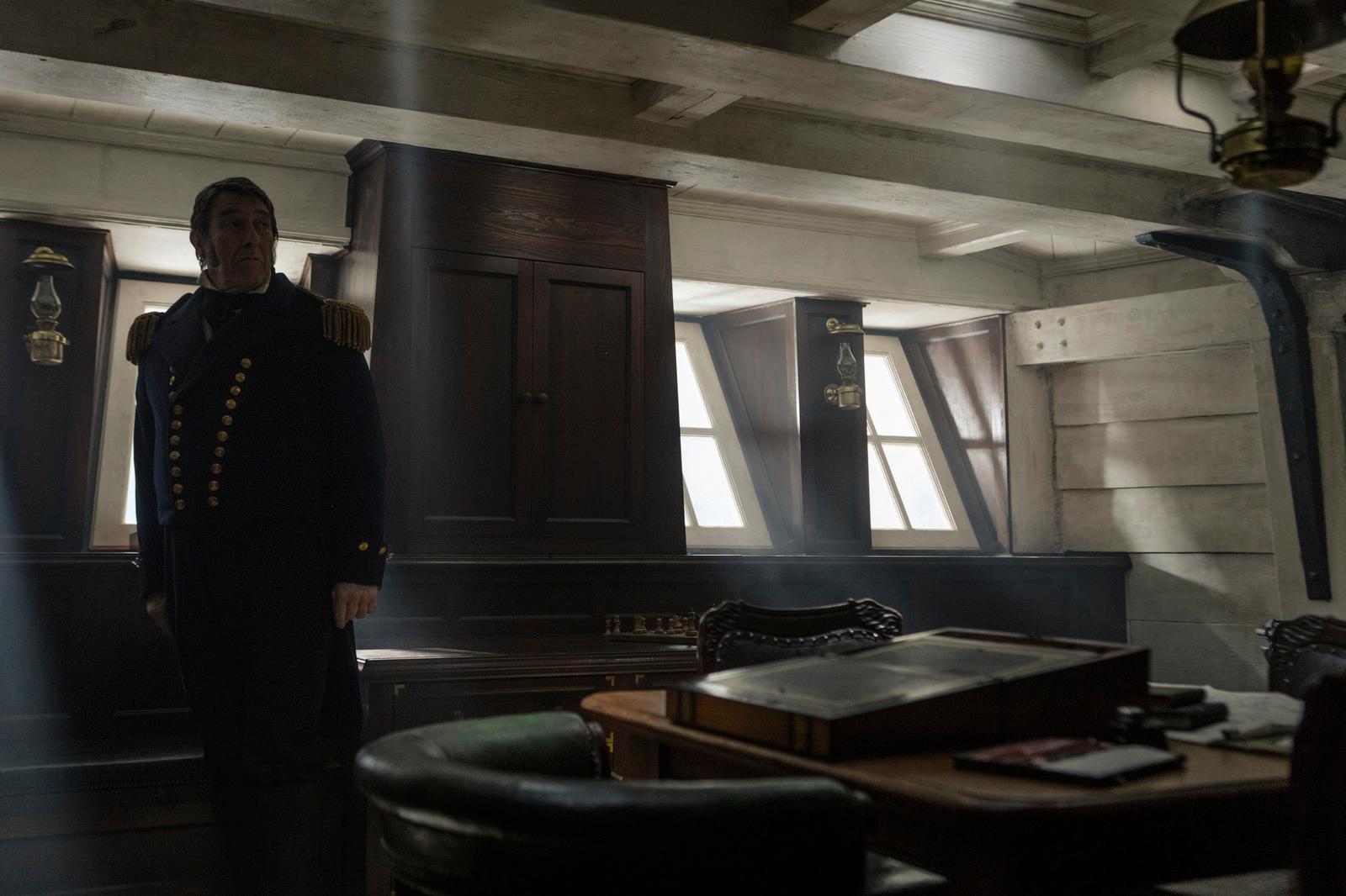 a man in uniform standing in a room