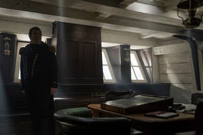 a man in uniform standing in a room