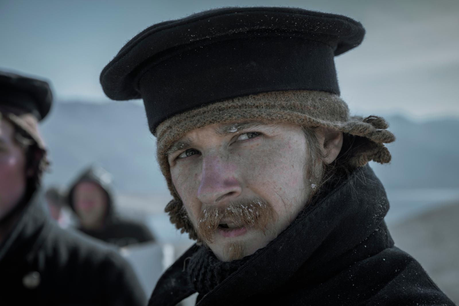 a man wearing a hat and a scarf