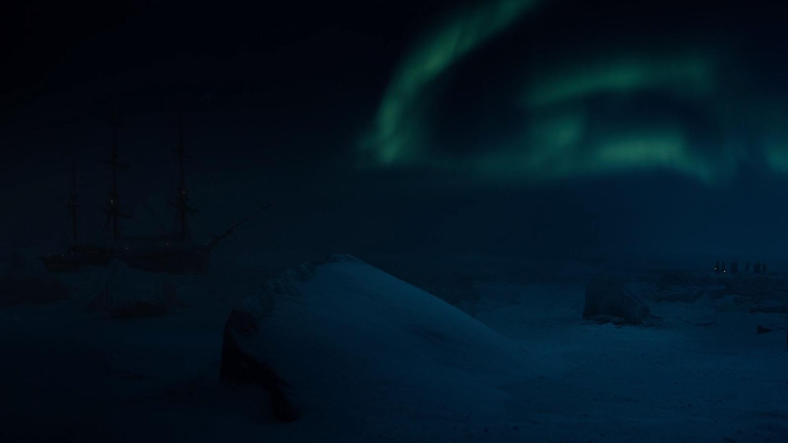 a boat sitting in the snow with the aurora in the background