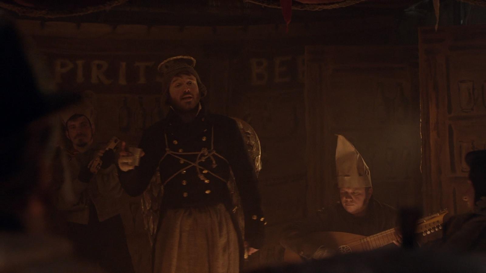 a group of men standing around each other in a room