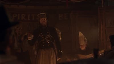 a group of men standing around each other in a room