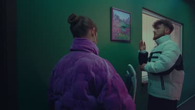 a man and a woman standing in a hallway