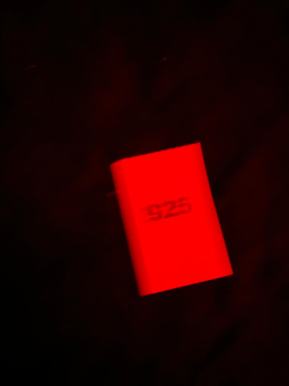 a close up of a red object in the dark