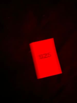 a close up of a red object in the dark