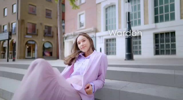 a woman sitting on the steps of a building
