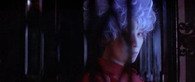 a person with white hair and a red shirt