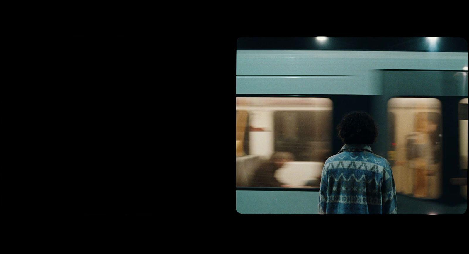 a man standing in front of a train at night