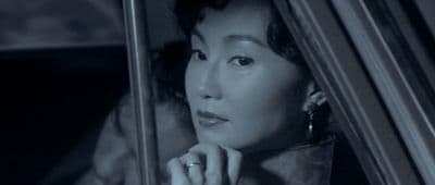 a woman sitting in a car looking out the window