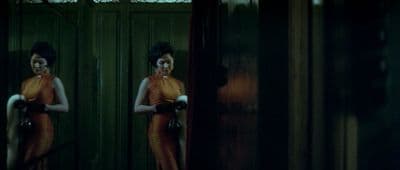 a woman standing in front of a green door