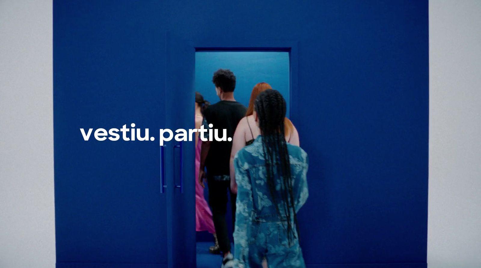 a man and a woman standing in front of a blue door