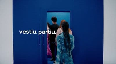 a man and a woman standing in front of a blue door