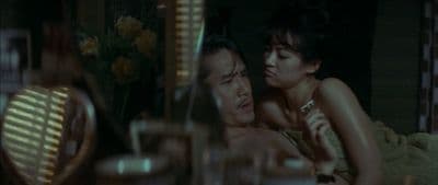 a man and a woman laying on a bed