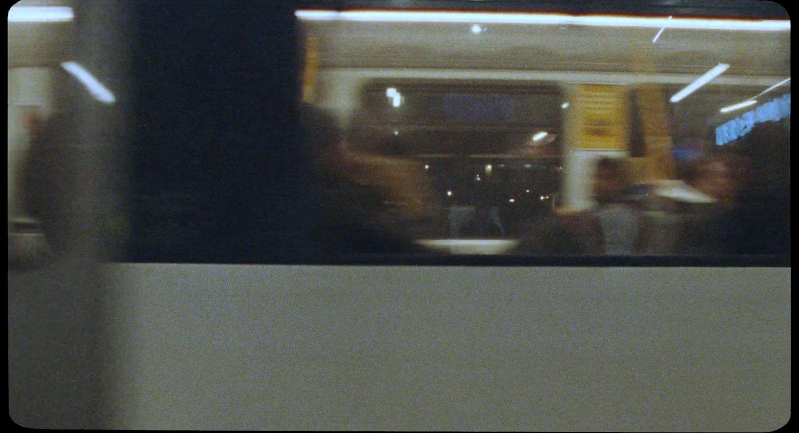 a blurry photo of people sitting on a train