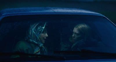 two women sitting in a car in the rain