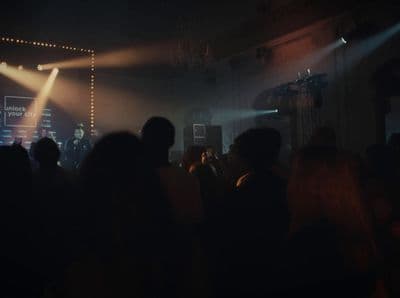 a crowd of people standing around a stage