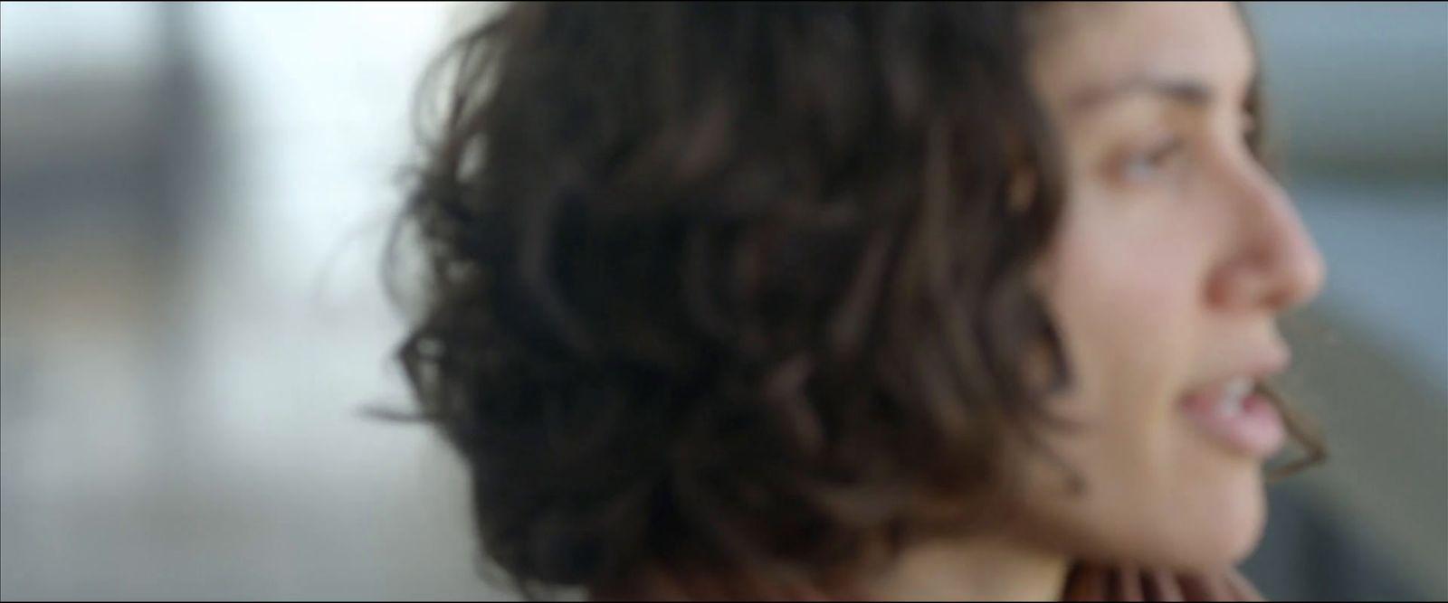 a close up of a person talking on a cell phone