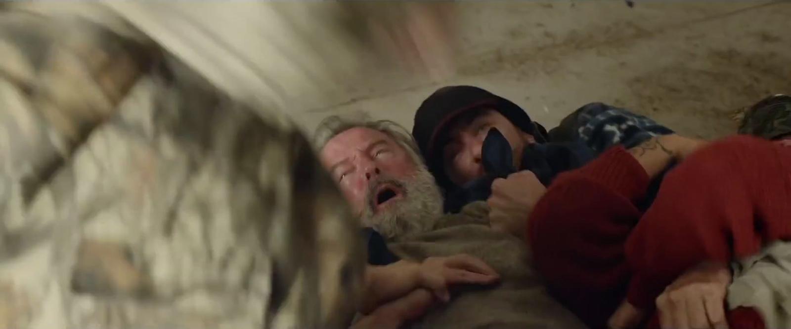 a group of people in a room with a man holding a baby