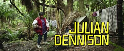 a man standing in a forest next to a tent
