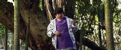 a man standing in the middle of a forest