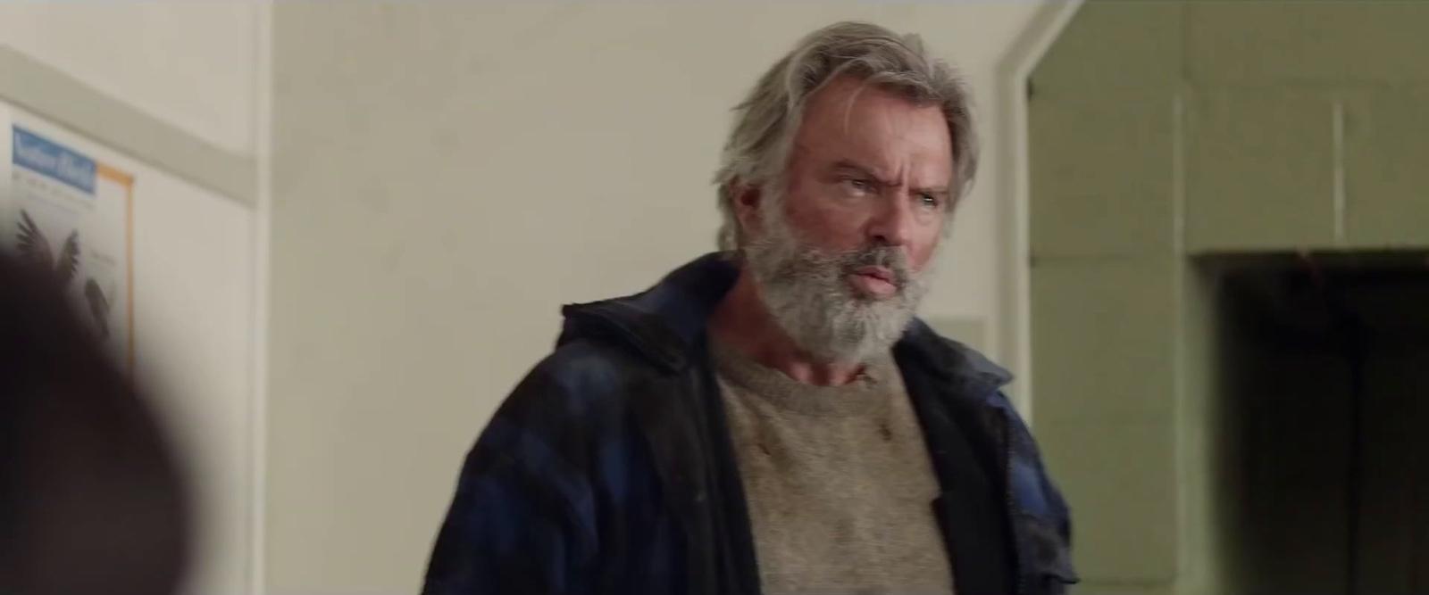 a man with a beard standing in a room