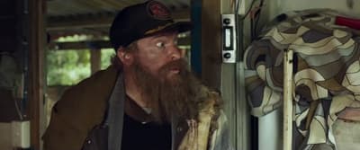 a man with a long beard wearing a hat