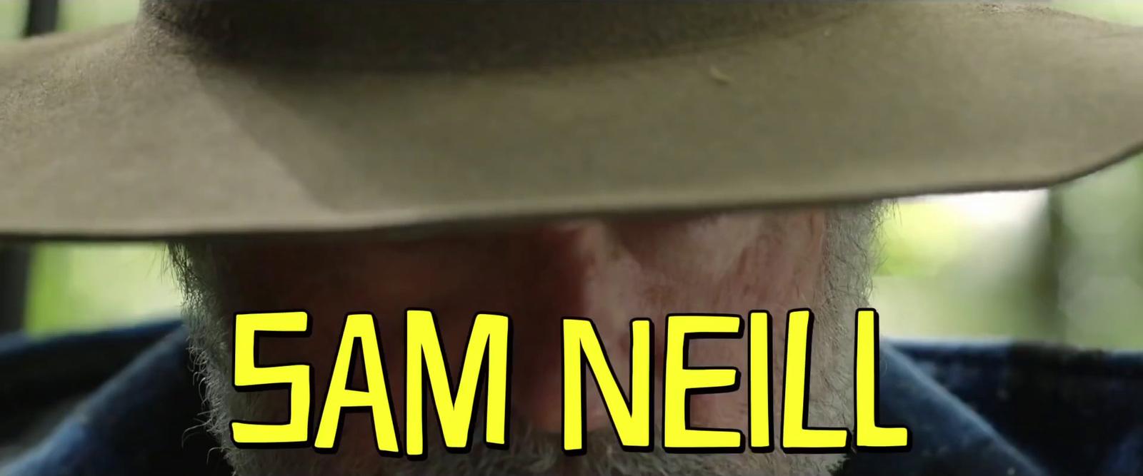 a man wearing a cowboy hat with the words sam neil on it