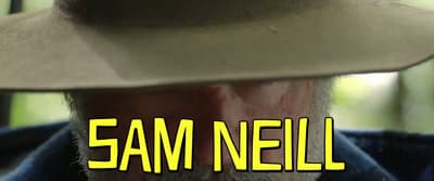 a man wearing a cowboy hat with the words sam neil on it
