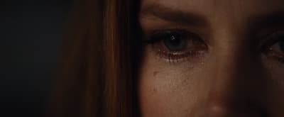 a close up of a woman's face with long red hair