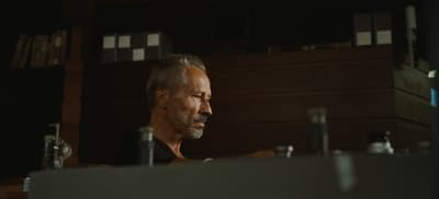 a man sitting at a desk in a dark room