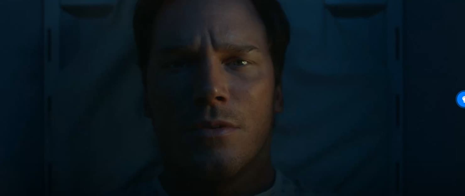 a man in a dark room staring at the camera