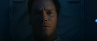 a man in a dark room staring at the camera