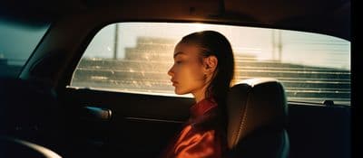 a woman sitting in the back seat of a car