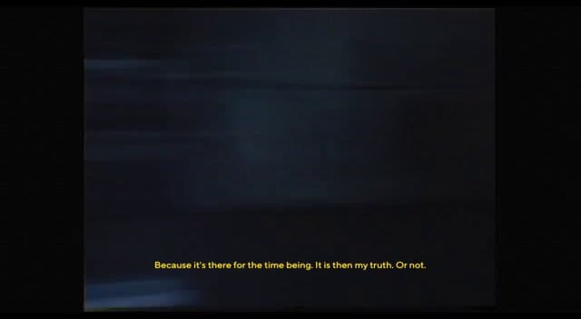 a blurry photo of a black background with a yellow text