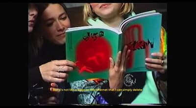 a woman reading a book to a little girl