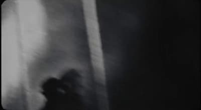 a blurry image of a person standing in front of a window